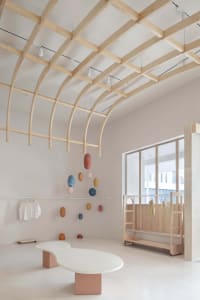 A minimalist retail space featuring concrete flooring and wooden accents.