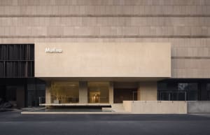 Modern storefront with concrete facade and glass windows.