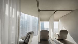 Contemporary seating area featuring modern leather chairs and glass panels.