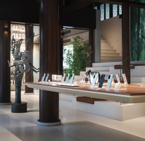 Retail storefront with wooden accents displaying various smartphones in a gradient color scheme.
