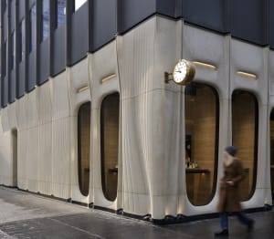Modern storefront with concrete walls and large windows.