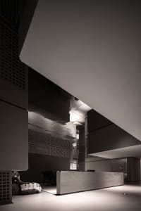 Modern industrial lobby featuring concrete walls and white walls.