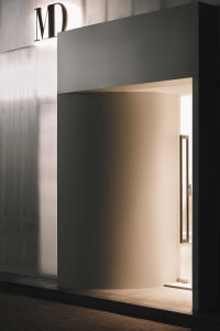 A curved entrance made of metal with a modern design.