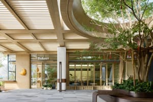 A modern bakery exterior with a wooden facade and large glass doors.