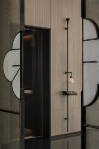 A modern entryway featuring glass and metal materials with a minimalist design aesthetic.