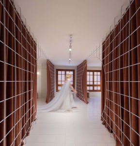 A modern industrial interior with curtains and a grid structure