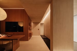 Modern interior space with wooden walls, floor, and furniture.