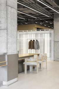A modern retail storefront with concrete walls and a minimalist design.