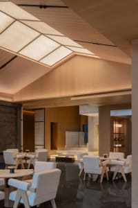 Modern coffee shop with wooden ceiling and marble tables and chairs