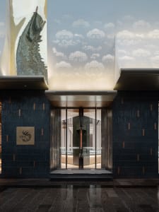 Modern, high-end retail storefront featuring glass doors and artistic facade