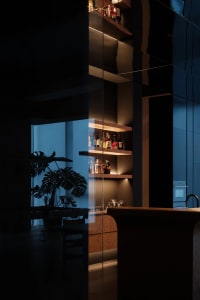 A modern, minimalist kitchen with wooden elements.
