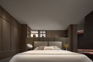 Minimalist bedroom featuring a headboard with a neutral color palette and simple design.