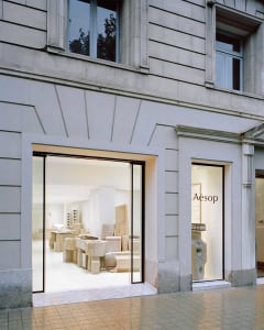 A modern retail storefront with stone elements and a minimalist design.