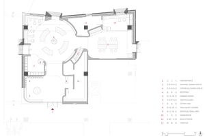 A floor plan of a modern office layout in black and white design, showing various functional zones and spatial composition.