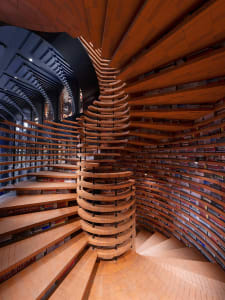 An industrial-style library with wooden architectural elements.