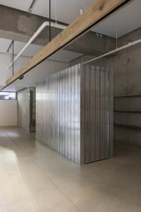 A minimalist interior space featuring a metallic storage unit.