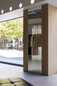 Modern clothing store with glass panels displaying elegant clothing.