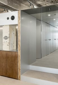 Modern office closet with metallic gray PVC paneling and concrete ceiling
