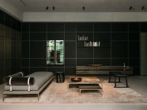 Modern minimalist living room featuring metal, glass, and black wood materials.