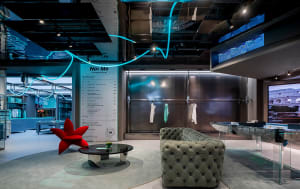 A modern retail storefront featuring concrete, glass, and metal materials.