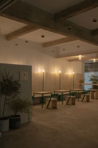 An industrial-style cafe interior with concrete walls and a minimalist design.