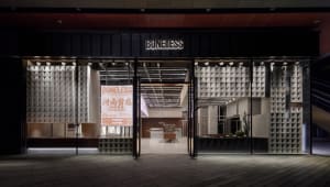 A modern commercial space with illuminated glass panels and industrial design elements.
