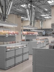 A retail space featuring metallic grid displays for food products.