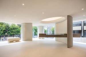 An image of a modern office space featuring minimalist design with concrete and wood elements.