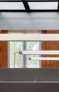 Suspended lighting in a modern office setting.