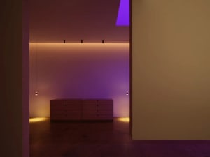 Minimalist room with concrete walls and floor, featuring simple furniture.