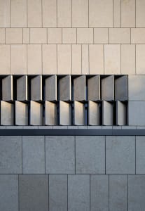 Modern building facade with concrete tiles and concrete columns.