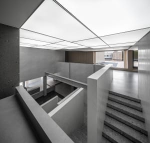A modern office space featuring a combination of concrete and marble materials.