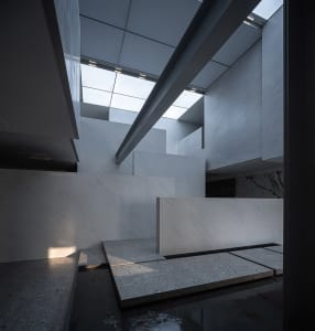 Modern office lobby interior with glass and concrete materials.