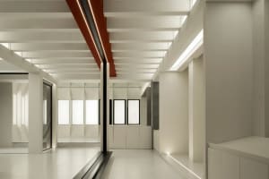 Modern office corridor featuring a white interior and metallic ceiling panels