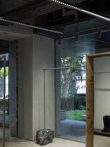 A modern storefront with glass walls and a concrete structure.