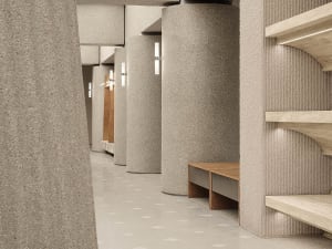 A modern interior space featuring concrete columns and a well-lit corridor with wooden benches.