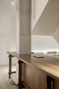 Minimalist workspace with wooden furniture and sleek, modern design.