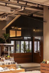 A modern event space entry with corrugated metal cladding and glass windows.