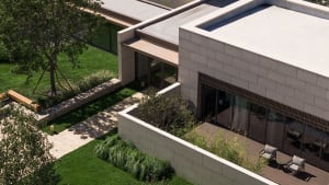 Modern building with concrete and glass exterior, featuring clean lines and large windows.
