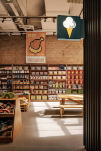 A pet supply store with wooden shelves displaying various products on a brick wall background.
