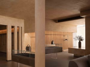 Interior view of a modern retail shop featuring a display counter made of marble with wood accents.