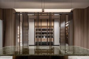 Modern storage closet with light wood finish and dark accents