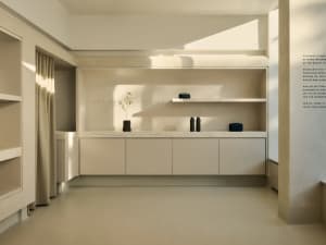 A minimalist interior space featuring a display case made of concrete.