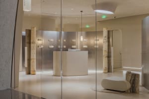 A sleek, modern retail storefront with concrete and marble features.