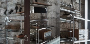 A modern storage shelf with glass and metal components.
