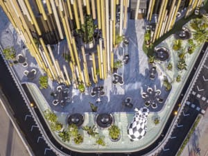 A modern urban green space featuring concrete and wooden elements.