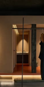 Modern minimalist bedroom with wood accents and a warm, inviting atmosphere.