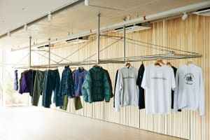 Retail clothing display featuring a selection of jackets, hoodies, and jeans.
