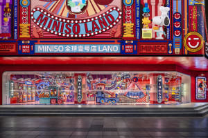 A vibrant and colorful storefront with glass display cases showcasing a variety of products.