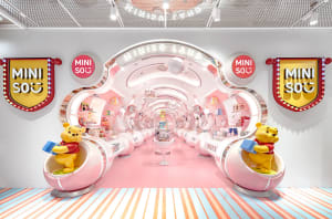 A brightly lit, futuristic retail space with plastic elements and a pink floor.